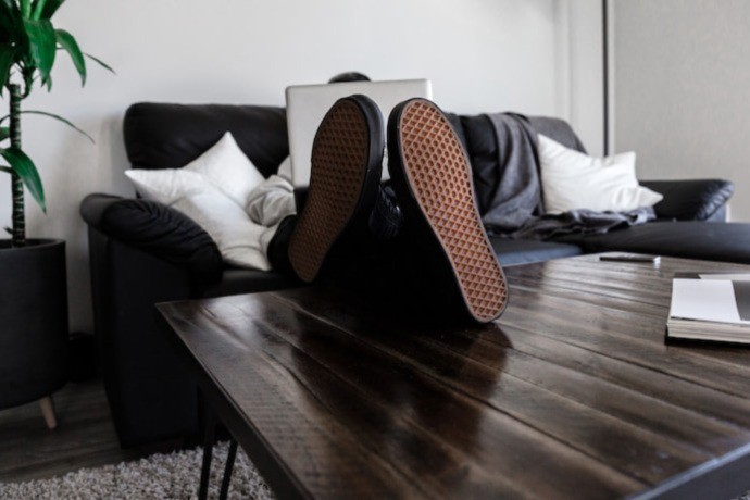 a person laying on the couch stress free