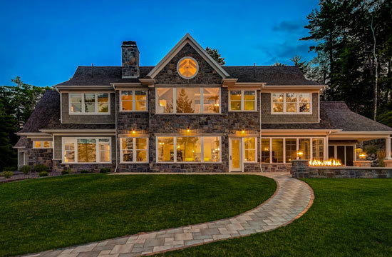 Modern black luxury home nestled in the woods.
