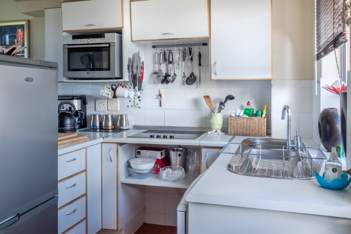 crowded galley kitchen with limited storage space