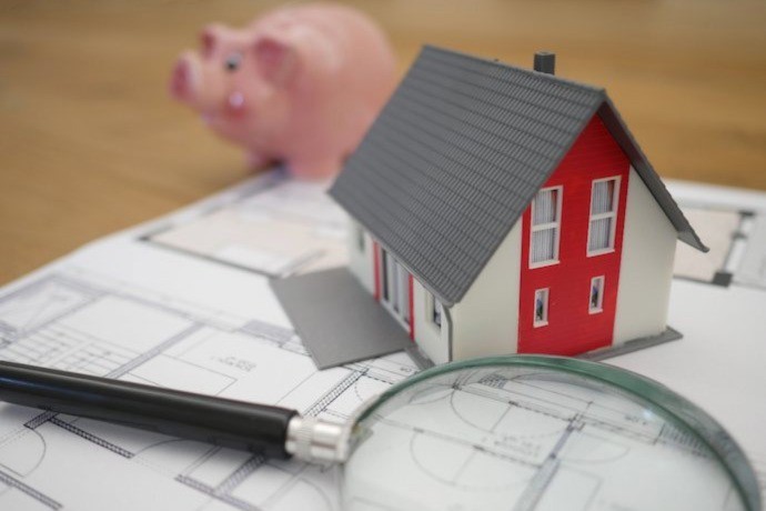 miniature house on the paper with the house renovation plan